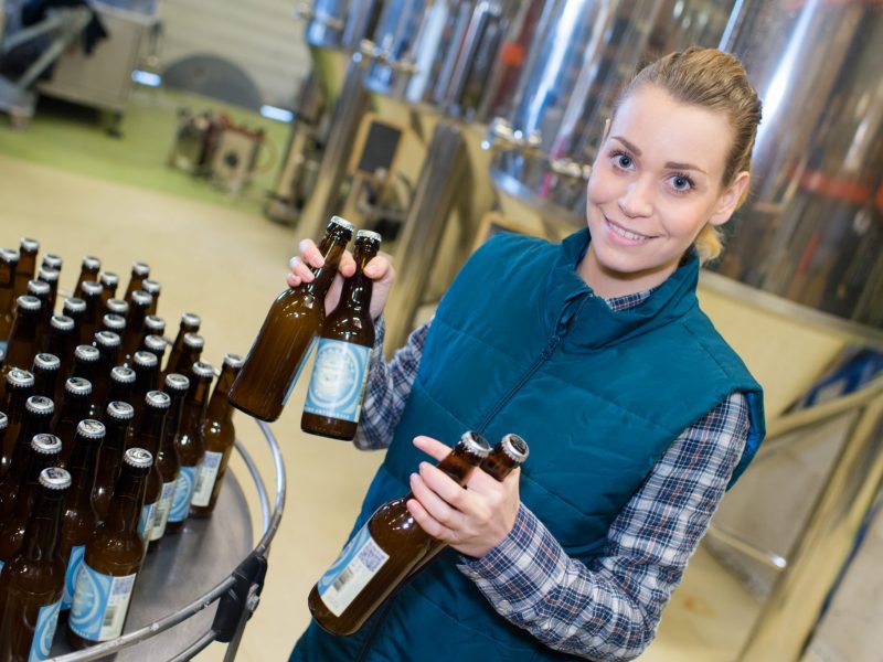 You Brew It, We'll brand It, beer branding agency, female worker in a beer bottleling factory