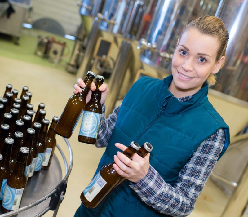 You Brew It, We'll brand It, beer branding agency, female worker in a beer bottleling factory